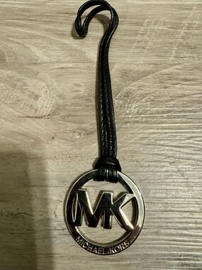 Michael Kors Logo Keychain: Chrome and Black. A chrome-plated pendant featuring